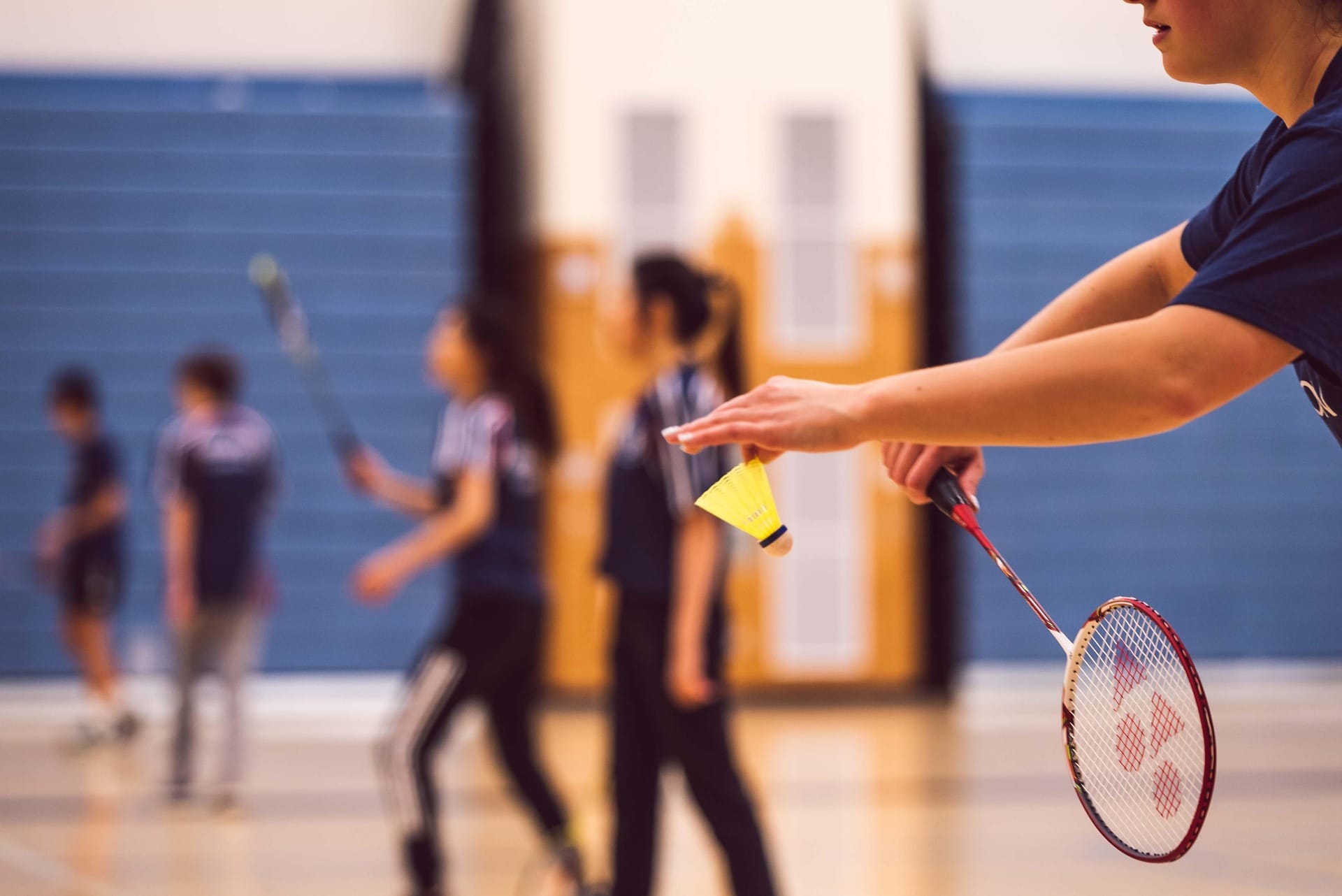 Badminton players in action on an indoor court